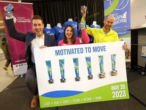 L-R: Tyler Hope, district manager, Servus Credit Union; Tracy Johnson, CEO, Calgary Public Library Foundation; and Jon Bird, executive director, Servus Calgary Marathon during a special collaboration announcement with the Calgary Public Library revealing the 2023 Servus Calgary Marathon medal at the Central Library in Calgary on Thursday, March 9, 2023.