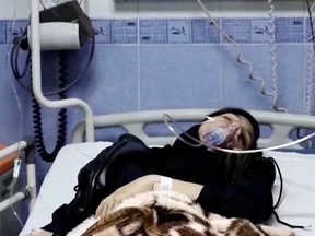 A young woman lies in hospital after reports of poisoning at an unspecified location in Iran in this still image from video from March 2, 2023.