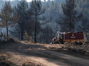 A fire truck is pictured in a forest area near the village of Los Peiros, on March 25, 2023, affected by a wildfire that began on March 23, 2023 near Villanueva de Viver, some 90 kilometres (55 miles) north of Valencia. - Hundreds of firefighters today were battling Spain's first major forest fire of the year, which has so far forced 1,500 people to evacuate their homes, officials said. Despite several days of unusually warm weather, firefighters said the blaze was more typical of the hot summer months than the spring.