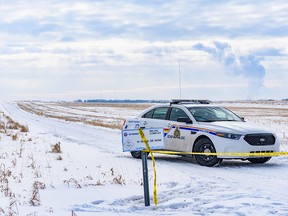 An RCMP cruiser blocks a road as officers investigate a crime scene near Airdrie on February 18, 2020.