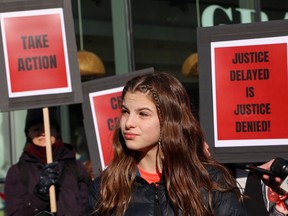 John A. Macdonald Junior High School student Makena Halvorsen takes part in a protest outside the Calgary Board of Education building to call for an end to delays in changing the name of John A. Macdonald Junior High School and the mascot name for John G. Diefenbaker High School.