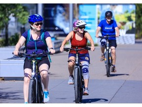 Cyclists ride e-bikes along the Bow River pathway in Calgary's East Village on Tuesday, August 16, 2022. 
Gavin Young/Postmedia