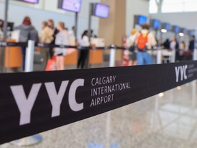 Travelers check in for flights at Calgary International Airport on Tuesday, August 23, 2022.