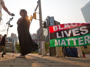 Organizer Taylor McNallie speaks to the media on Monday, July 26, 2021 at a protest organized outside the Calgary Courts Centre. McNallie, 32, faces four charges, including assaulting an off-duty female sheriff.