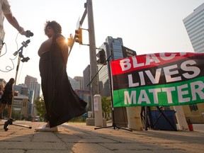 Organizer Taylor McNallie speaks to the media on Monday, July 26, 2021 at a protest organized outside the Calgary Courts Centre.  McNallie, 32, faces four charges, including assaulting an off-duty female sheriff.