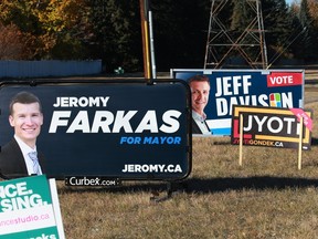 Campaign signs showing three of the frontrunners in the race for Calgary mayor are seen along 66th Avenue S.W. in Lakeview on Tuesday, Oct. 12, 2021.