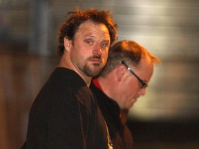 An officer arrests Christopher Dunlop on September 7, 2012, three years after Laura Furlan's body was discovered in Fish Creek Park.  Dunlop is now charged with second-degree murder and indignity to a body in the death of 58-year-old Judy Maerz.