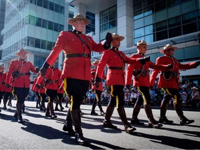 Members of the RCMP march during the Calgary Stampede parade in Calgary, Friday, July 6, 2018.