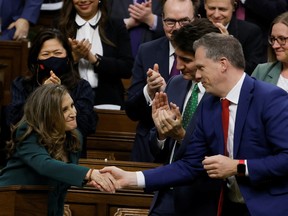 Canada's Deputy Prime Minister and Minister of Finance Chrystia Freeland and Leader of the Government in the House of Commons Mark Holland shake hands as she presents the federal government budget for fiscal year 2023-24 in the House of Commons on Parliament Hill in Ottawa, Ontario, Canada March 28, 2023.
