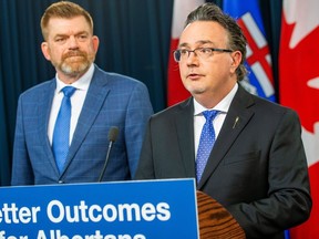 Red Tape Reduction Minister Dale Nally, right, speaks at a press conference in Edmonton on March 8, 2023, as Brian Jean, minister for Jobs, Economy and Northern Development, listens on.