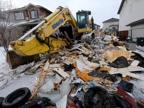 Remains of the fatal house fire on Citadel Way N.W. in Calgary on Saturday, March 25, 2023.