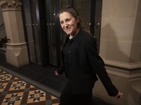 Deputy Prime Minister and Finance Minister Chrystia Freeland pauses to speak with reporters in February.
