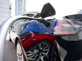 An electric vehicle is charged in Ottawa on Wednesday, July 13, 2022. Ottawa is expected to make big investments in clean energy and technology in the upcoming budget as it tries to keep competitive in the transition toward a greener economy.