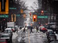 People carry umbrellas while crossing Robson Street as rain falls in Vancouver, on Thursday, January 6, 2022. Canada's intelligence service warns that technological innovations adopted by municipalities could be exploited by adversaries such as the Chinese government to harvest sensitive data, target diaspora communities and interfere in elections.