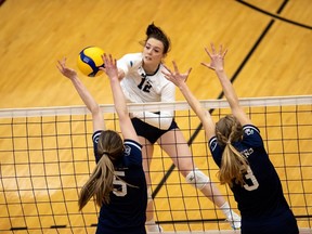 The Mount Royal University Cougars’ Haley Roe spikes the ball against the Trinity Western University Spartans during the U SPORTS Women’s Volleyball Championship match at the Jack Simpson Gym at the University of Calgary on March 27, 2022.