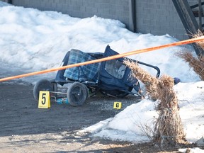 A baby stroller lies on its side Tuesday, March 14, 2023 on the scene of the fatal incident in Amqui, Que. Two people were killed and nine others were injured Monday afternoon when a pickup truck plowed into pedestrians who were walking beside a road in the eastern Quebec town.