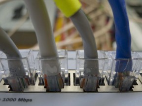 Canada's auditor general says the federal government's slow rollout of high-speed internet to rural areas is putting First Nations at an economic disadvantage. Internet cables connect to a switch on a home network in Chelsea, Que., Monday July 11, 2011.
