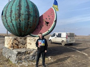 Calgarian Mac Hughes in Kherson region last month poses in front of a watermelon, a fruit synonymous with the area. He was on his way to deliver aid to the war-torn area.