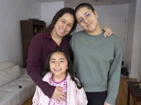Asylum seekers from Colombia: Maria Fernanda Lopez and her daughters, Alejandra Ortiz and Sarah Cortes, pose for photos in their apartment, Monday, Feb. 27, 2023, in Montreal.