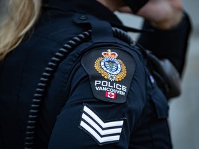 A Vancouver Police Department patch is seen on an officer's uniform as she makes a phone call after responding to an unknown incident in Vancouver, B.C., Saturday, Jan. 9, 2021.