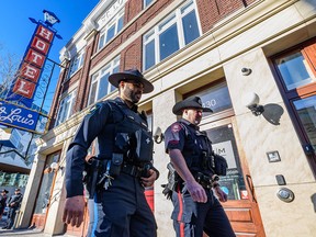 Alberta sheriff Prabhjot Singh, left, and Calgary police Const. Brad Milne walk outside the CPS East Village Safety Hub on Feb. 14, 2023.