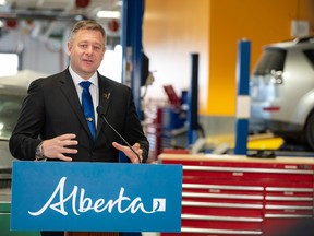 Shane Getson, parliamentary secretary for Economic Corridors and chair of the Career Education Task Force, speaks at a press conference at Forest Lawn high school's auto-mechanics shop on April 17.
