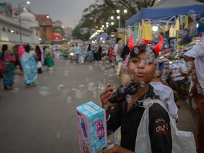 A boy blows bubbles to attract customers on a street ahead of Eid al-Fitr on April 21, 2023 in Bengaluru, India. Eid Al-Fitr is the “festival of the breaking of the fast” and marks the end of the Muslim holy month of Ramadan, celebrated by Muslims throughout the world, where a month-long dawn-to-sunset fast comes to an end.