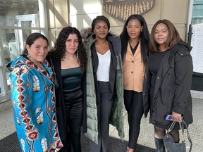 Supporters of murdered SAIT basketball star John Smith Jr. at the Calgary Courts Center on Monday April 3, 2023 where his killer pleaded guilty to manslaughter. From left to right Eileen Gullion, her daughter Michaela Allen-Gullion, Smith's sisters Krystal and Sade and mother Cylon Bates.