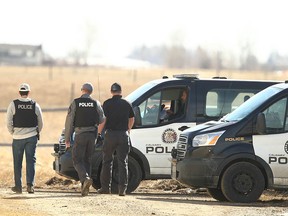 Police are shown at an area on Vale View Road east of Chestermere, east of Calgary, on Monday, April 10.