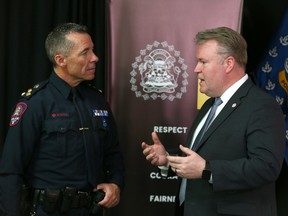 Calgary Police Chief Mark Neufeld (L) chats with Gurvais Grigg, Chief Technology Officer at Chainalysis at Calgary police headquarters in Calgary on Wednesday, April 12, 2023. The CPS and Chainalysis have become partners in the creation of an investigative training centre.