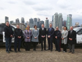 Dignitaries pose in Calgary on Friday, April 14, 2023. The provincial government has announced funding to help people struggling with addiction and mental health access much-needed support.