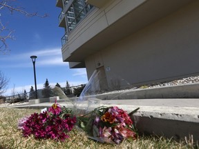 Flowers are shown outside the apartment condo complex in Spruce Cliff in southwest Calgary on Tuesday, April 18. Police are investigating the two deaths as a murder suicide.