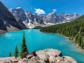 Turquoise water of Moraine Lake with snow capped peaks above in Banff National Park of Canada.