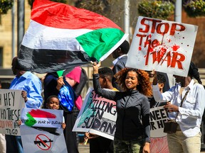 Calgarians rally against the war in Sudan outside City Hall on Sunday, April 30, 2023.