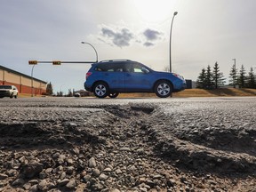 A large pothole awaits repair along Sunridge Blvd. N.E. in Calgary on Sunday, April 16, 2023.