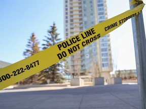Police crime scene tape remained at Spruce Place S.W. on Sunday, April 16, 2023 after two deaths occurred in public in that area on Saturday evening. The Calgary Police Service’s Victim Assistance Support Team was deployed to the area on Sunday afternoon to help support those who witnessed the deaths.