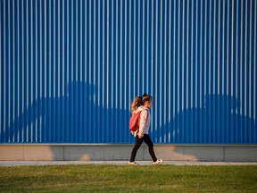 An elementary school student walks to the first day of classes at a school in southeast Calgary on Thursday, September 1, 2022.