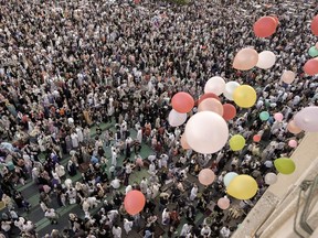 Balloons are distributed for free after Eid al-Fitr prayers, marking the end of the Muslim holy fasting month of Ramadan outside al-Seddik mosque in Cairo, Egypt, Friday, April 21, 2023.
