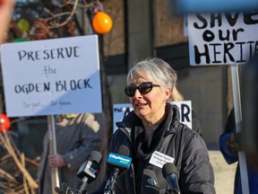 Bonny Warbeck with the Millican Ogden Heritage Group speaks to the media outside the historic building at 7044 Ogden Road that the group hopes to save from demolition on Wednesday, April 5, 2023. The building, originally a Chinese laundry, was slated for demolition as part of construction for the Green Line.
