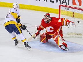 Nashville Predators forward Tommy Novak scores the decisive goal in the shootout on Calgary Flames goaltender Jacob Markstrom at the Scotiabank Saddledome on Monday, April 10, 2023.