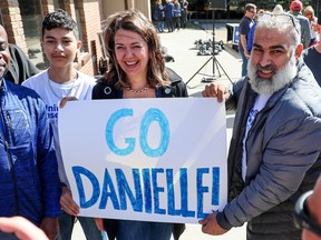 Alberta Premier Danielle Smith greets supporter Mahmoud Mourra, right, and his son after a UCP campaign launch event in Calgary on Saturday, April 29, 2023.