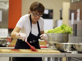 A volunteer with Brown Bagging for Calgary's Kids prepares lunches in 2011.