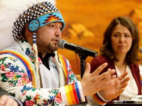 Enoch Cree Nation Chief Cody Thomas, left, takes part in a news conference on Monday, April 24, 2023, where he signed a memorandum of understanding with Premier Danielle Smith for the development of a new 75-bed recovery facility on the First Nation.