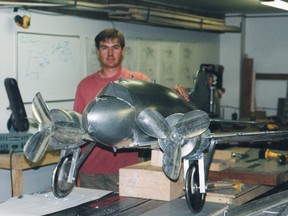 Artist Jeff de Boer works on one of the tin planes.