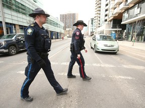 Calgary Police Service Sgt. Mike Anderson and Acting Sgt. Eric LeGreeley walk a beat in downtown Calgary.