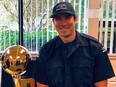 Sawada with the Larry O'Brien NBA Championship Trophy while working with the City of Burnaby Fire Department.
