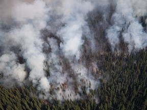 The White Rock Lake wildfire burns west of Vernon, B.C., on Thursday, August 12, 2021. A growing wildfire in British Columbia has forced officials to issue an alert for a First Nations community in the province's Cariboo region to be ready for evacuation.