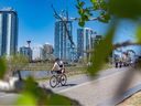 People enjoy the warm and sunny weather along Bow River Road in East Village on May 5.