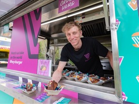 Logan Hamilton, manager of VBurger, poses for a photo with a Habanero Cherry Ice cream Taco at the 2023 Calgary Stampede midway food launch at ENMAX Park on May 10.