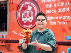 The Happy Fish food truck owner Ying Yansita poses for a photo with a Seafood Michelada at the 2023 Calgary Stampede midway food launch on May 10.